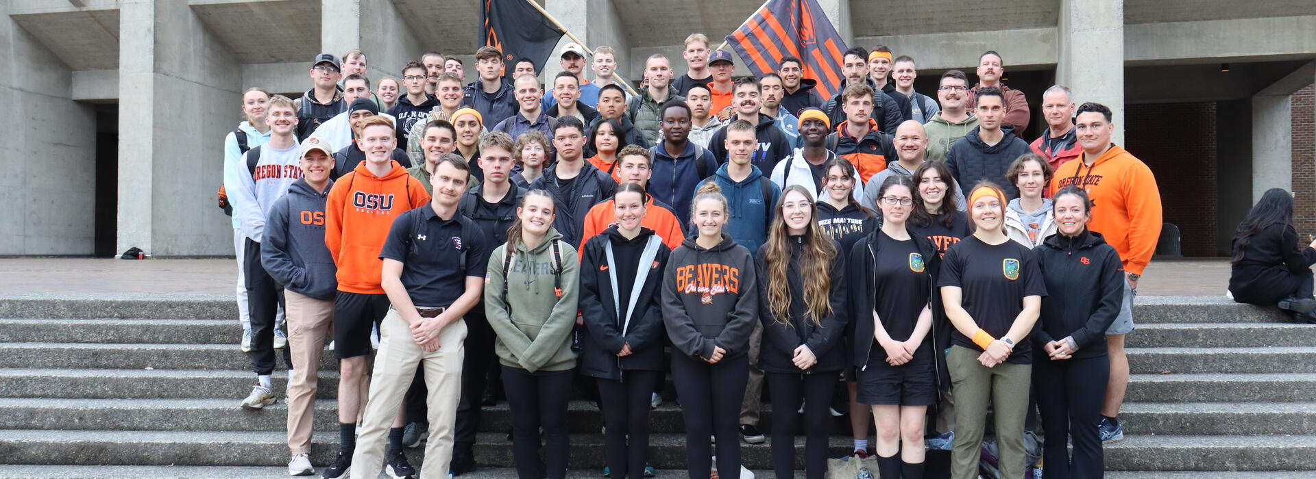 Group of students, standing on steps, all in OSU Beaver clothing. 