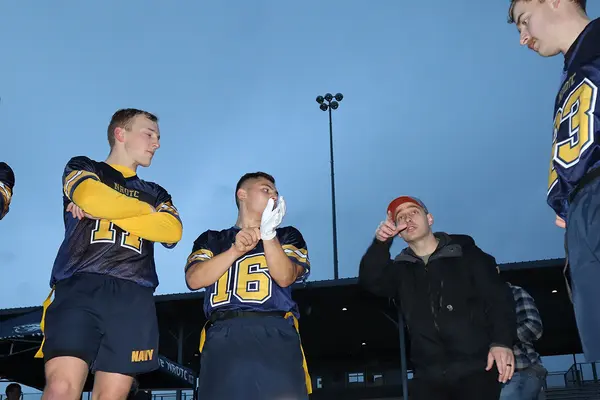 NROTC students huddle to plan football strategies