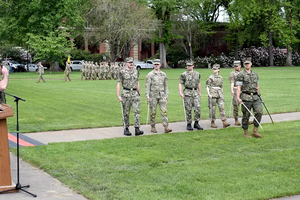 Students being saluted as they march past. 